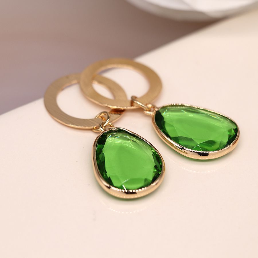 Golden scratched circle and green drop earrings
