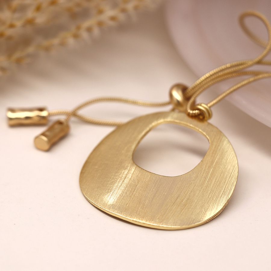 Long faux gold plated disc pendant